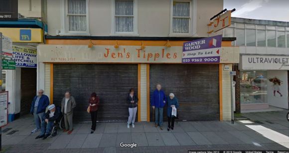 People waiting for bus in front of empty business called Jen's Tipples
